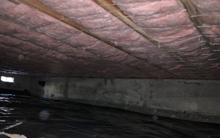 A room with pink insulation on the ceiling.