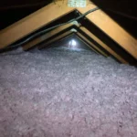 A view of the inside of an attic with lights.