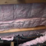 A pink wall with insulation in it